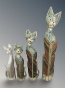 Four wooden cat figures,