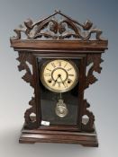 An early 20th century mantel clock with pendulum and key.