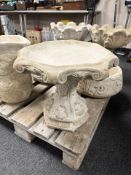 A concrete garden bird bath.