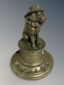 A novelty brass figure of a dog on stand, height 15 cm.