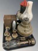 A group of antique metal wares including an antique biscuit tin in the form of a stack of books,