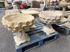 A pair of concrete garden pineapple urns.