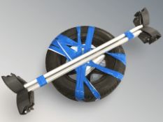 A spare wheel together with a tub of motor oil and a roof rack.