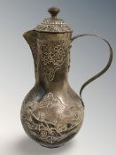 A 19th century Continental copper water jug decorated with hunting scene with silver-wash overlay,
