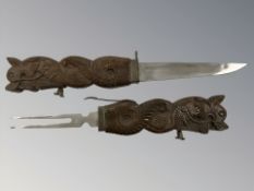 An Indian carved wooden integral knife and fork,