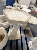 A concrete garden hexagonal bird bath.