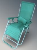 A folding turquoise lounger chair.