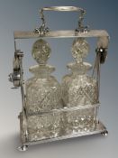 A late Victorian silver plated two bottled Tantalus, no key.