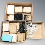 Two boxes of buttons and sequins,