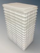 A stack of white catering trays