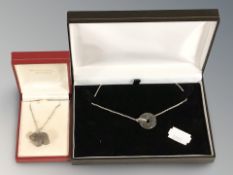 A silver and jadeite hoop necklace and a silver and carved jadeite polar bear pendant.