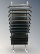 A stainless steel rack on wheels with non stick trays