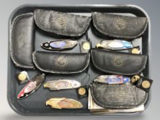 A group of modern folding knives depicting Harley Davidson motorcycles.