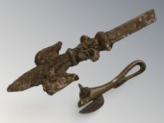 A vintage tin opener modelled as a bull together with a metal finial