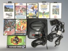 A Sega Mega Drive II with controllers and games