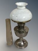 A metal 20th century paraffin lamp with glass shade
