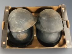 A group of military metal helmets.