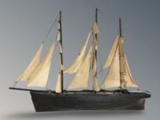 A wooden scratch built model of a three masted ship, width 90 cm.