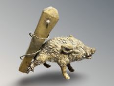 A cast brass antique figure of a boar chained to a post, height 9 cm.