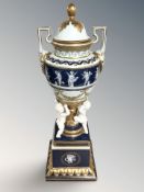 A Continental gilded urn with cover decorated with cherubs