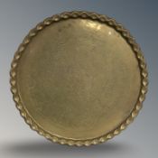 A large brass plaque or charger