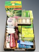 A crate of un-used skin products, body wash and soap, pack of washing powder,