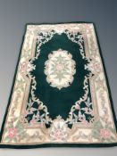A green floral Chinese rug, 151 cm x 240 cm.