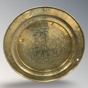 A large brass charger, diameter 96 cm.