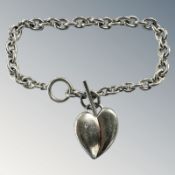 A silver bracelet with diamond set heart pendant CONDITION REPORT: 27.4g.
