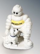 A cast iron Michelin man and dog group, height 20 cm.