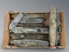 A quantity of scale model battleships and an aircraft carrier.