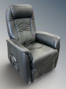 A contemporary black leather reclining armchair,