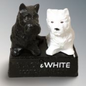 A cast iron group of two scottie dogs 'Black and White' scotch whisky, height 15 cm.