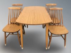 A teak veneered drop leaf dining table,
