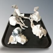 Four Nao figures of ballerinas and a further group of two puppies.