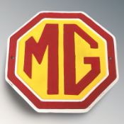 A cast iron MG plaque, diameter 24 cm.