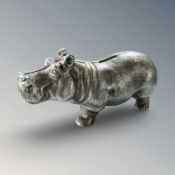 A cast iron hippo money bank, length 21 cm.