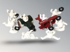 A group of miniature cast iron Michelin man figures, largest 11 cm long.