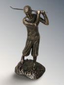 A bronzed metal figure of a golfer, height 29 cm.