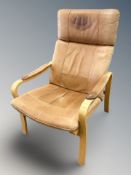 A Scandinavian bentwood and tan leather lounge armchair,