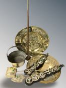 Two brass chargers, horse brasses, jam pan, a copper and brass horn.