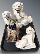 Three 20th century Staffordshire dogs and a Staffordshire figure of a Scotsman.