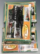 Three Christmas themed model train sets.