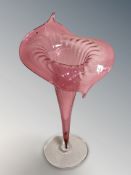 A cranberry glass spill vase in the form of a lily, height 31 cm.