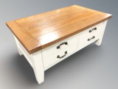A modern oak topped four drawer storage coffee table,