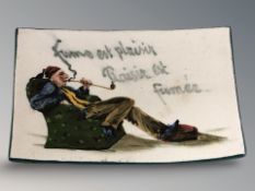 A Wemyss crackle glazed curved rectangular ashtray depicting figure smoking a pipe, 14 cm x 10 cm.