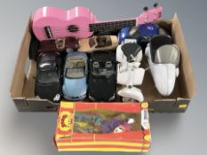 A group of die cast scale model cars including Maisto, ukulele,