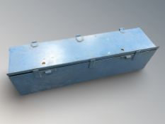 An enameled metal foot locker / box, length 126 cm.