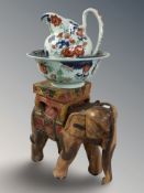 A carved and painted hardwood elephant plant stand, height 40 cm,
