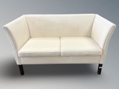 A late 20th century Danish two seater settee in cream upholstery,